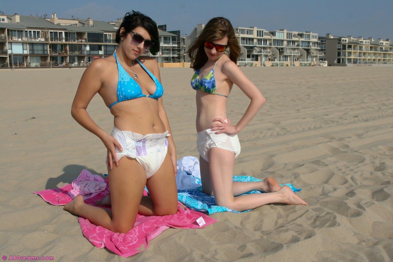 Two women were seated for a photo shoot with a view of the beach.